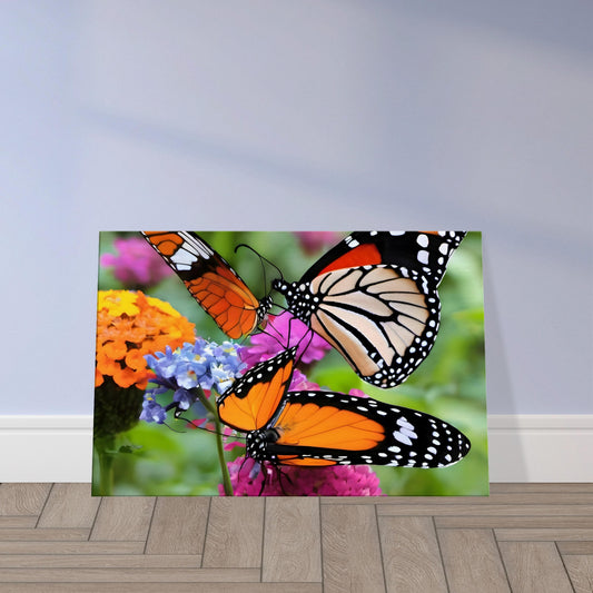 Canvas print depicting two monarch butterflies perched on vibrant plants in a lush garden setting.