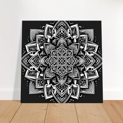 Mandala artwork featuring bold geometric patterns and fine filigree detailing in black and white for a dramatic, modern aesthetic.