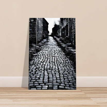 Black and white canvas of an old cobbled street lined with aged buildings and deep shadows